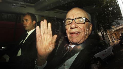 Rupert Murdoch leaves News International headquarters in Wapping, east London, with News International Group General Manager Will Lewis.