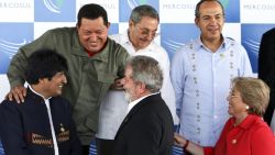 Presidents Hugo Chavez (top, L) of Venezuela, Raul Castro (top, C) of Cuba, Felipe Calderon (top, R) of Mexico, Evo Morales (bottom, L) of Bolivia, Luiz Inacio Lula da Silva (bottom, C) of Brazil, and Michelle Bachelet of Chile, chat during the family picture of the Mercosur Summit, held, with guests, in the framework of the South America and the Caribbean Summit, in Sauipe, Brazil, on December 16, 2008. The Brazilian coastal resort od Costa do Sauipe is being the venue for three days of summits by Latin American leaders preoccupied with the economic crisis creeping across their region. AFP PHOTO/ANTONIO SCORZA (Photo credit should read ANTONIO SCORZA/AFP via Getty Images)