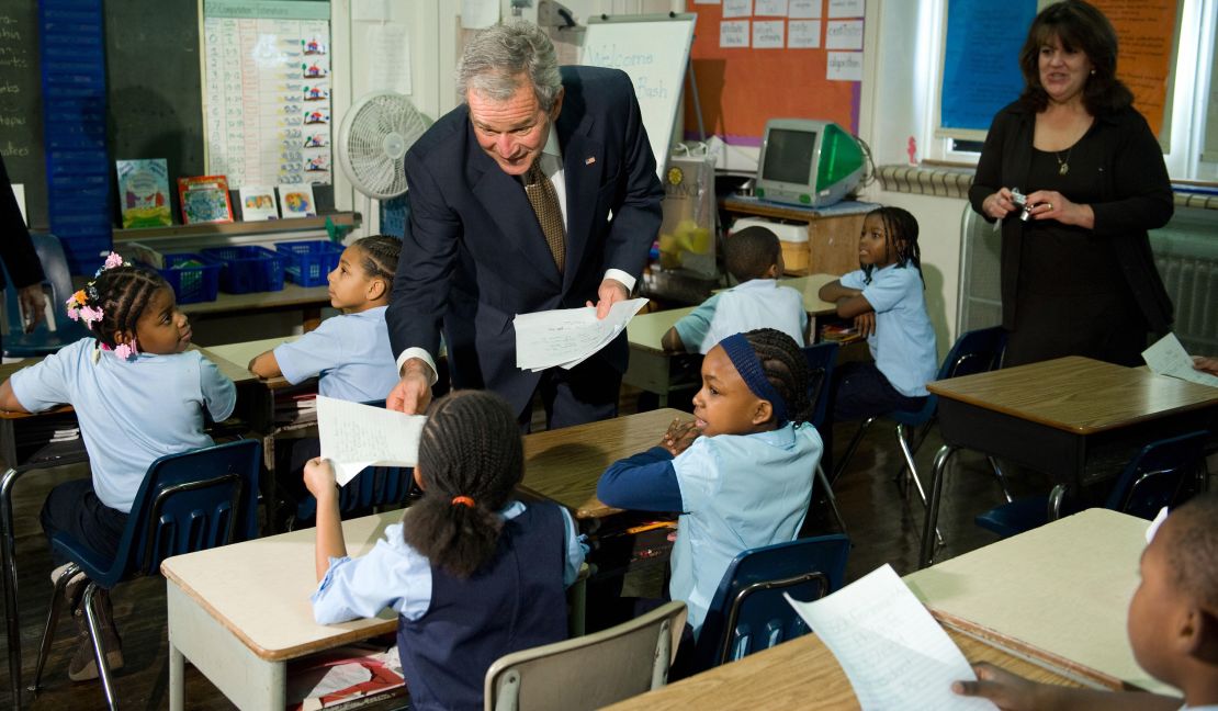 President George W. Bush talks with 2nd graders while picking up letters they wrote to him during a classroom visit at General Philip Kearny School in Philadelphia, Pennsylvania, on January 8, 2009.