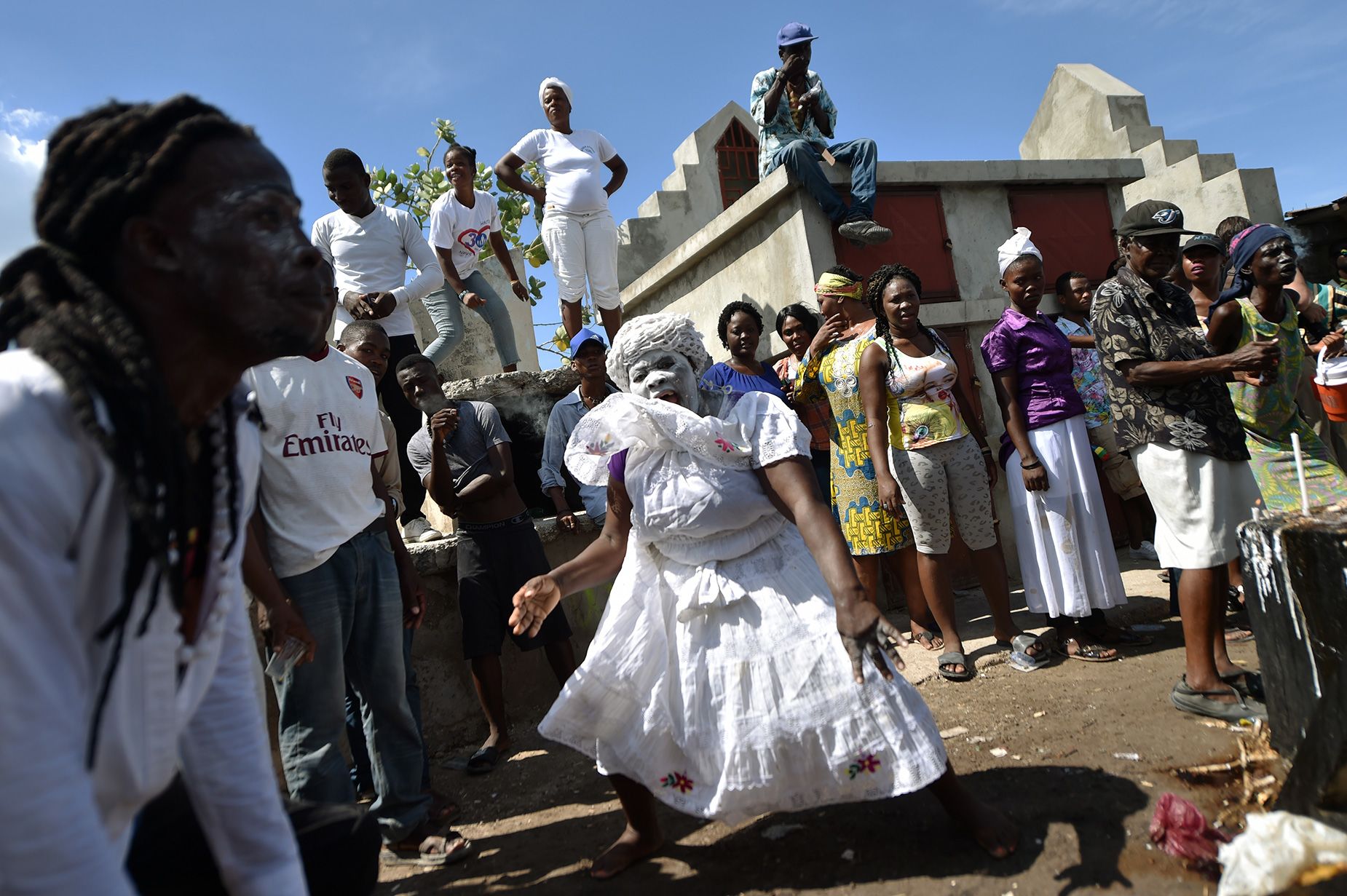 A woman devotee in the role of a spirit known as a Gede is seen during ceremonies honoring the Haitian voodoo spirit of Baron Samdi and Gede on the Day of the Dead in the Cementery of Cite Soleil, in Port-au-Prince, Haiti on November 1, 2017.