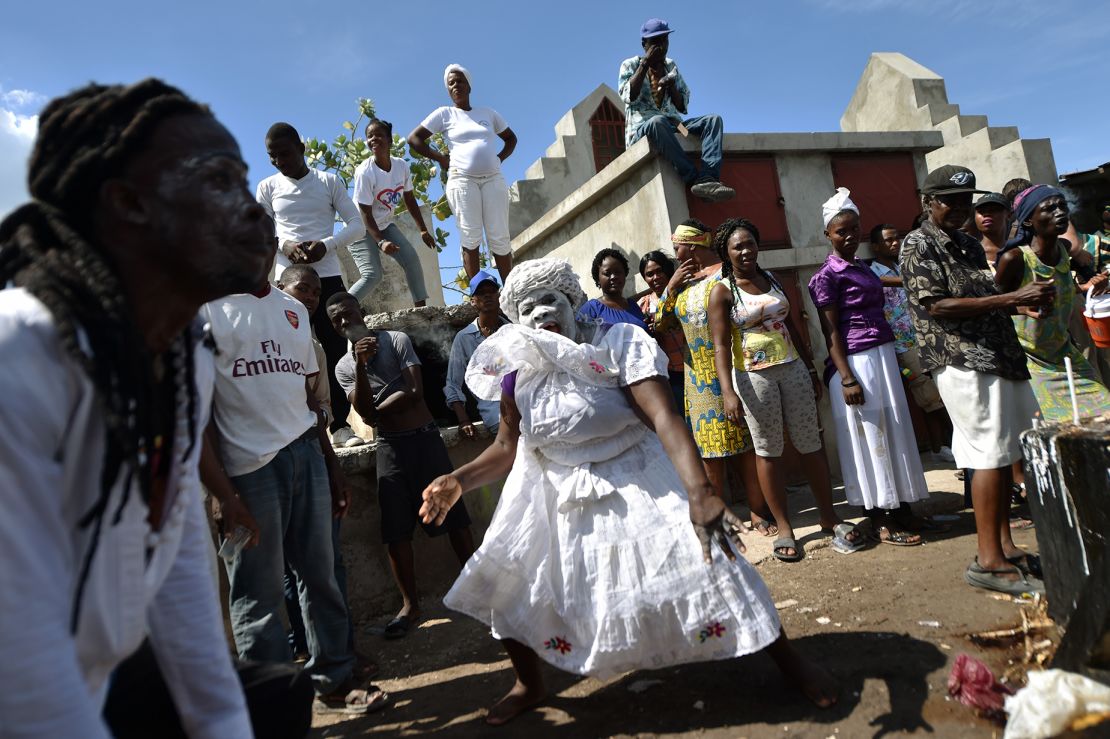A woman devotee in the role of a spirit known as a Gede is seen during ceremonies honoring the Haitian voodoo spirit of Baron Samdi and Gede on the Day of the Dead in the Cementery of Cite Soleil, in Port-au-Prince, Haiti on November 1, 2017.