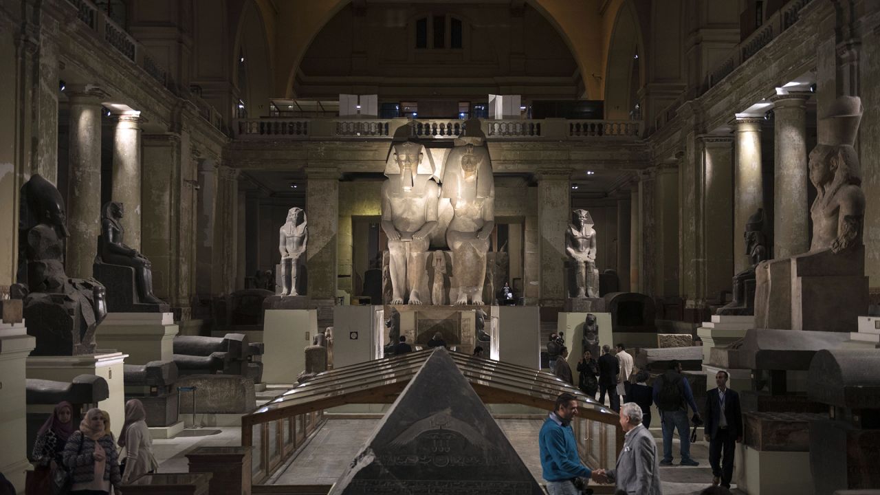 A picture taken on November 28, 2017 shows visitors walking through the main gallery of the Egyptian Museum, open late during a celebration of the 115th anniversary of its establishment.
The Egyptian Museum, founded in 1902, celebrated the anniversary by displaying for the first time some 60 golden pieces of the chariot of King Tutankhamun among its other 120 thousand artefacts. / AFP PHOTO / MOHAMED EL-SHAHED        (Photo credit should read MOHAMED EL-SHAHED/AFP via Getty Images)