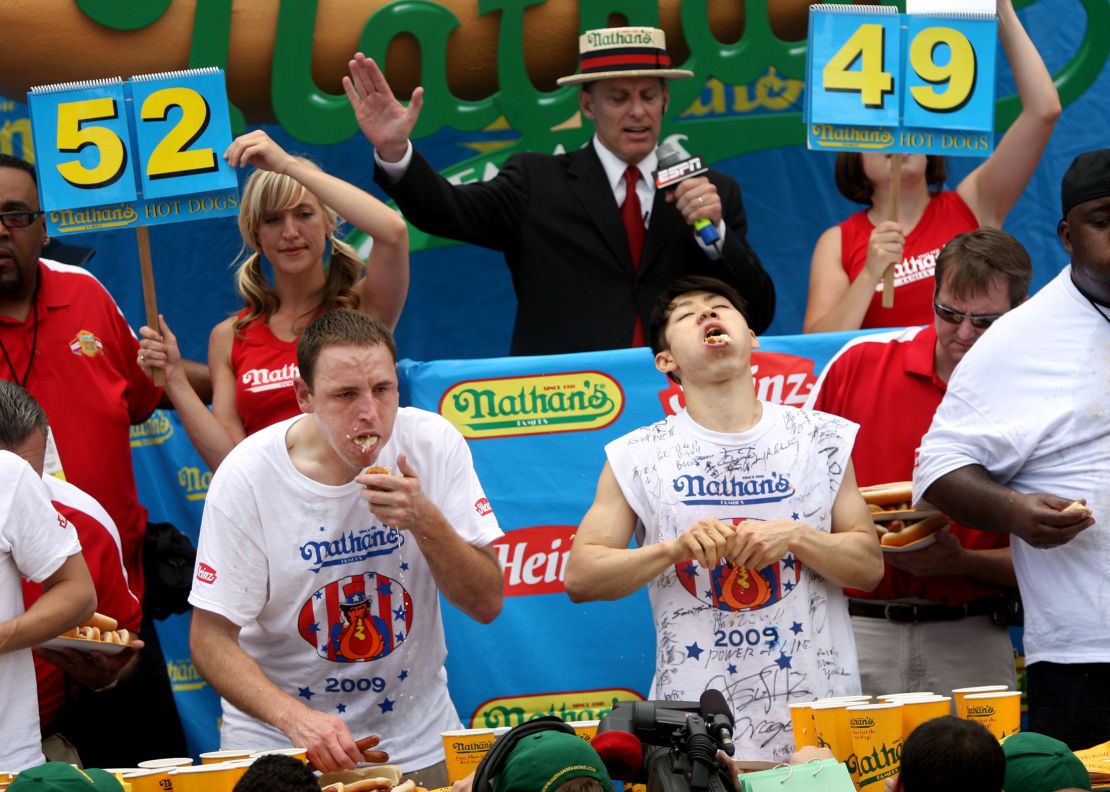 Joey Chestnut and Takeru Kobayashi stuff hot dogs into their mouths during Nathan's Famous Fourth of July hot dog eating contest in Coney Island in New York City, on July 4, 2009. Chestnut defeated Kobayashi with eating 68 to his 64.5 hotdogs.