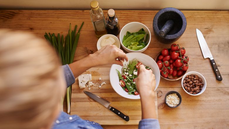 Cropped shot of an unrecognizable woman using ingredients to make a healthy salad