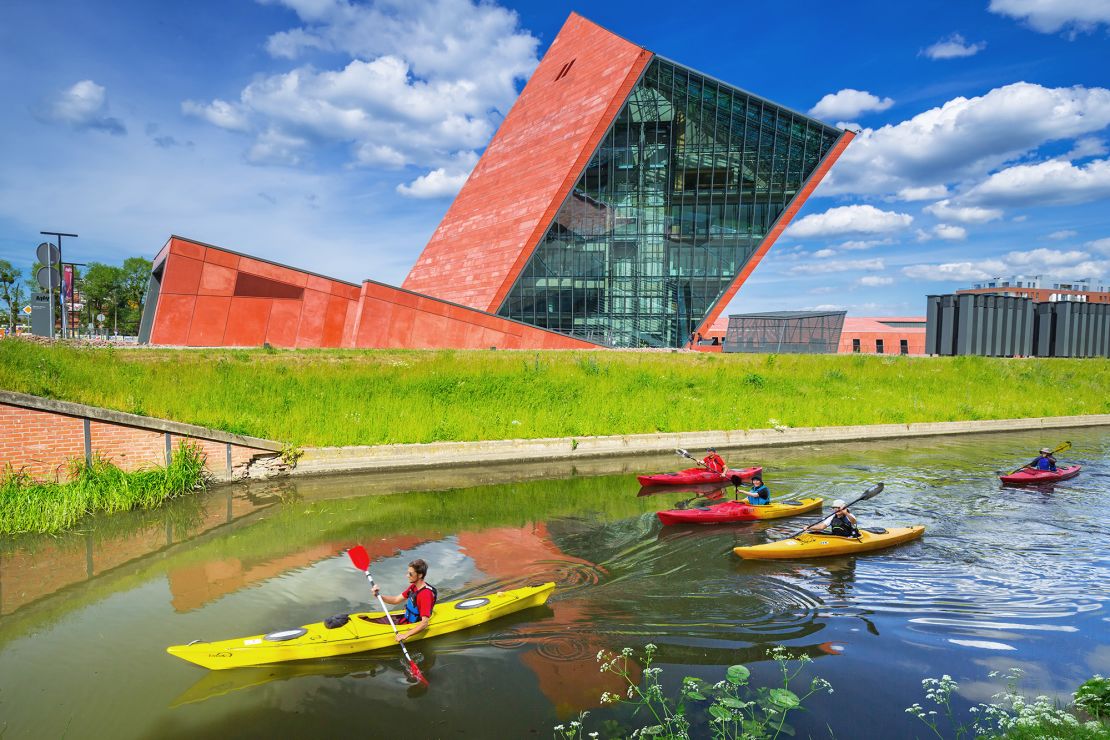 Kayakers glide past the Museum of the Second World War in Gdansk, Poland.