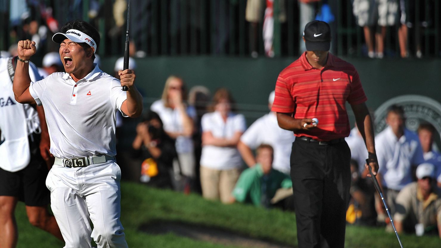 Y.E. Yang (left) celebrates after sinking his putt to beat Tiger Woods (right) to the 2009 PGA Championship title at Hazeltine National Golf Club in Chaska, Minnesota.