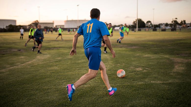 Male footballer lining up to kick the football.