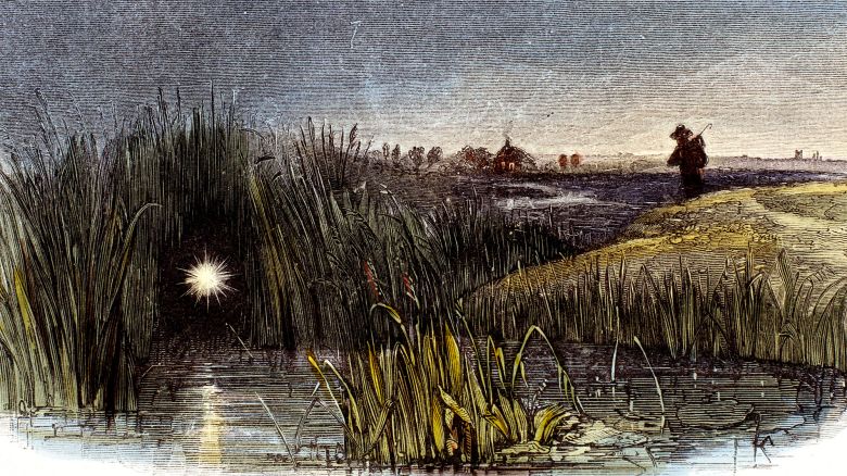 UNITED KINGDOM - FEBRUARY 08:  Detail from an engraving by Josiah Wood Whymper from 'Phenomena of Nature', published in London in 1849 for the Society for Promoting Christian Knowledge. 'In marshy and boggy places, a light is sometimes seen to hover over the ground by night, appearing from a distance like a taper gleaming from some cottage window. The light is caused by the lighting up of an inflammable gas produced by decaying animal and vegetable matter in bogs, marshes and stagnant pools. It is found that when damp soils are drained, the Will-o'-the-Wisp disappears.'  (Photo by SSPL/Getty Images)