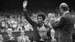 Arthur Ashe with the Wimbledon trophy after he beat the defending champion Jimmy Connors in four sets, 6-1, 6-1, 5-7, 6-4 6th July 1975. (Photo by Staff/Mirrorpix/Getty Images)