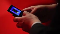 BRIGHTON, ENGLAND - SEPTEMBER 30:  A delegate plays a game of tetris on his mobile phone during the speeches on the fourth day of the Labour Party Conference on September 30, 2009 in Brighton, England. The Labour Party Conference enters its fourth day with debates on fairness and equality in Britain and keynote speeches from deputy leader Harriet Harman and schools secretary Ed Balls.  (Photo by Oli Scarff/Getty Images)