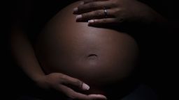 Close up of mixed race woman's pregnant stomach