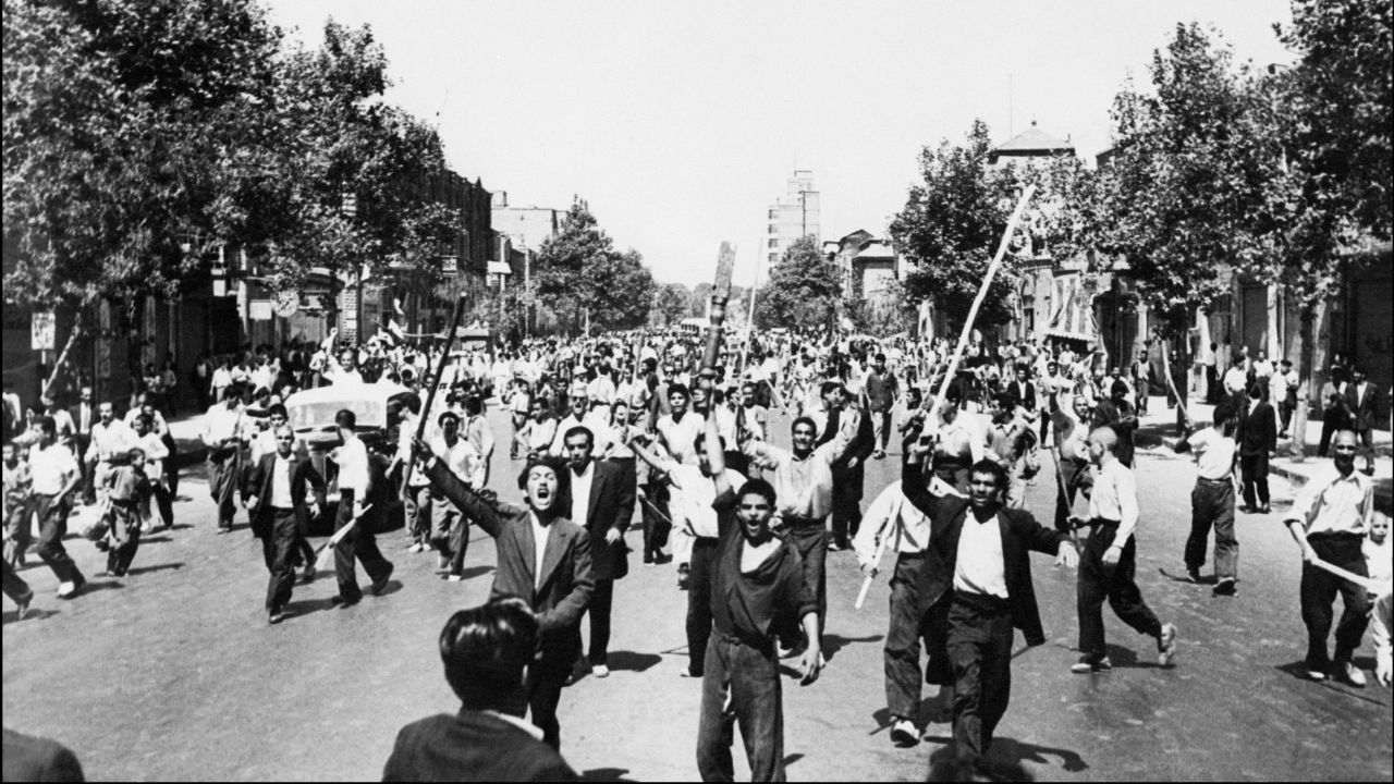 Pro-monarchy rioters take to the streets of Tehran in August 1953.
