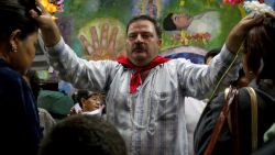 Mexican witch doctor Ariel Gonzalez participates in a ritual of prayer and healing at the Espinazo community in Nuevo Leon State, Mexico on October 17, 2009, celebrating the birth of "Nino Fidencio" (Kid Fidencio). Jose Fidencio de Jesus Constantino Sintora (1898-1938), known as "El Nino Fidencio", was a famous Mexican witch doctor venerated still nowadays in northern Mexico. AFP PHOTO/Juan Carlos REYES (Photo credit should read Juan Carlos REYES/AFP via Getty Images)