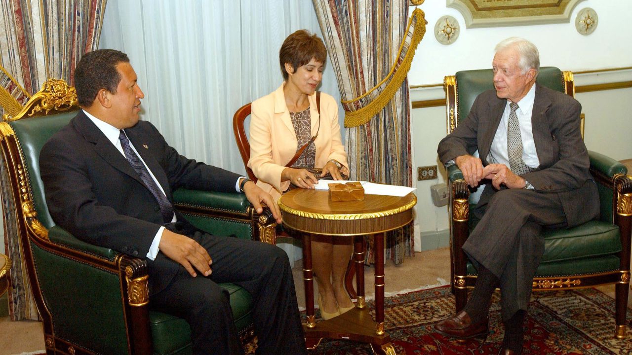 CARACAS, VENEZUELA - July 6:  Venezuelan President Hugo Chavez (L) speaks with  former U.S. President Jimmy Carter as an unidentified interpreter translates (C) July 6, 2002 at Caracas Miraflores presidential palace in Venezuela. Carter is in Venezuela for a four-day visit to help revive talks between the government and opposition parties, which have been locked in a power struggle since a failed coup attempt against President Chavez. Carter is in Venezuela at the invitation of the Chavez government.  (Photo by Miraflores/Getty Images)