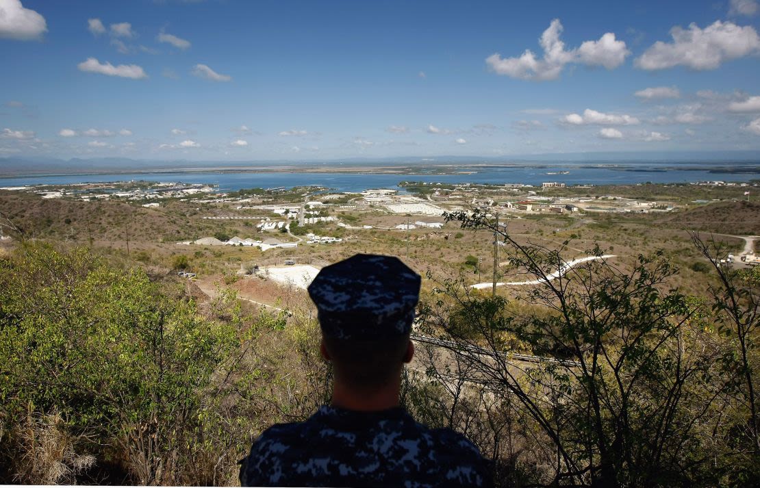 In this archive image reviewed by the US army, a member of the US Navy observes the US naval base in the Bay of Guantanamo, Cuba.