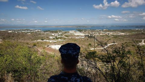 In this file image reviewed by the US military, a US Navy sailor looks out over the US Naval Base at Guantanamo Bay, Cuba.