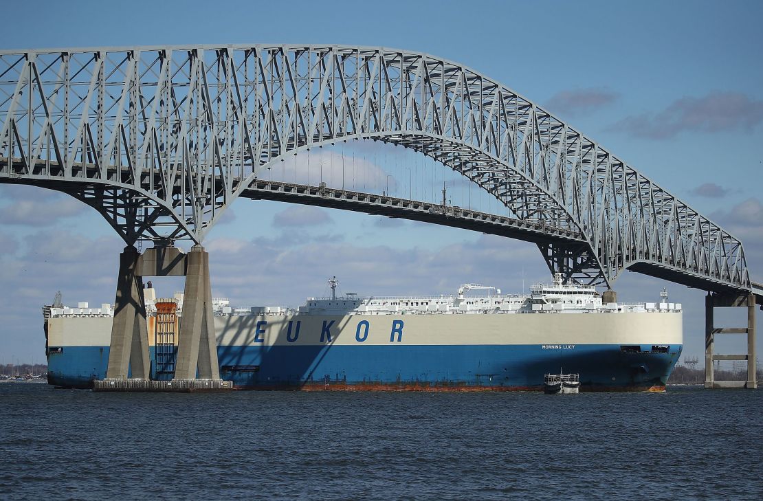 An outbound cargo ship passes under the Francis Scott Key Bridge, March 9, 2018 in Baltimore, Maryland.