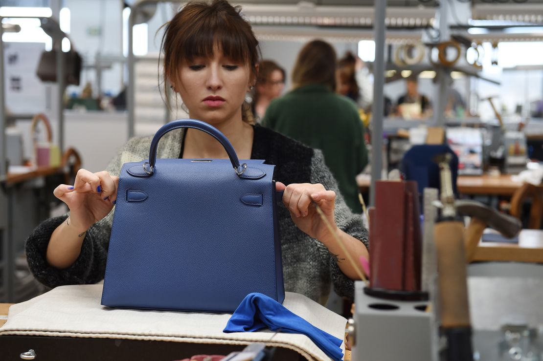 A craftsperson works on a purse in an Hermès leather goods workshop in Allenjoie, France on April 5, 2018.