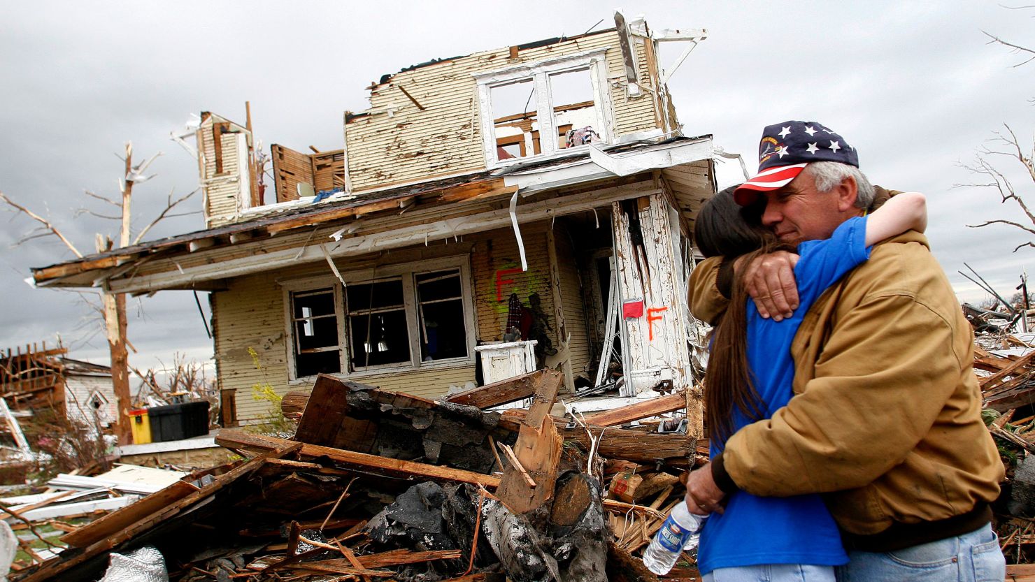 Lonnie McCollum, mayor of Greensburg, Kansas, is comforted by his daughter Shana Pittenger in front of his destroyed home on May 9, 2007. An EF-5 tornado leveled nearly the entire town.