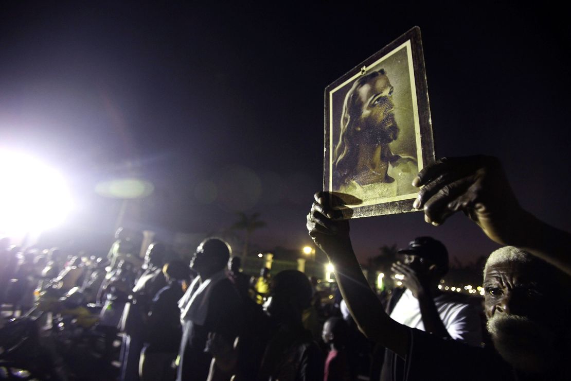 A survivor holds the Warner Sallman image of Jesus Christ during services on February 12, 2010, in Port-au-Prince, Haiti, after an earthquake devastated the country.