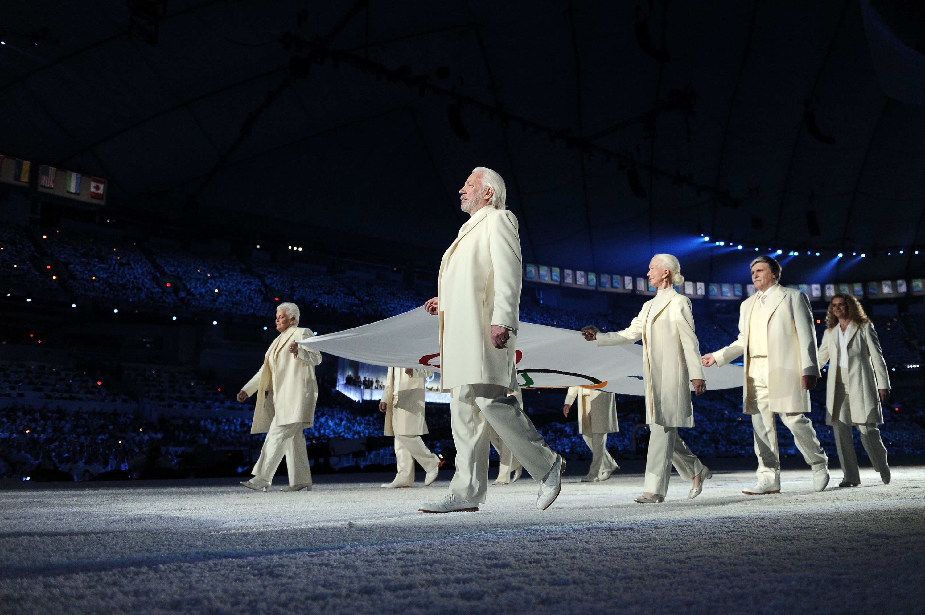 Sutherland helps carry the Olympic flag during the opening ceremony of the 2010 Winter Olympics in Vancouver.