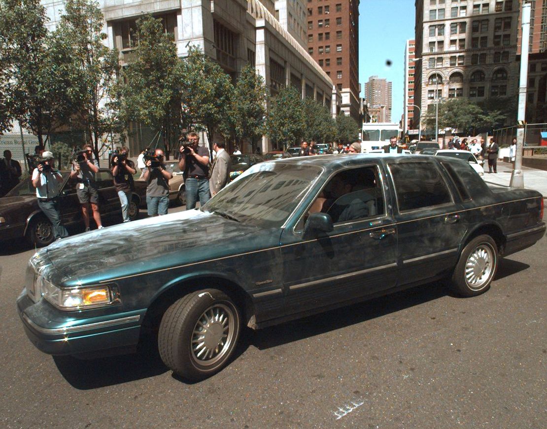 A Lincoln Town Car belonging to Sante and Kenneth Kimes and covered with fingerprint dust is driven out of FBI Headquarters in New York.