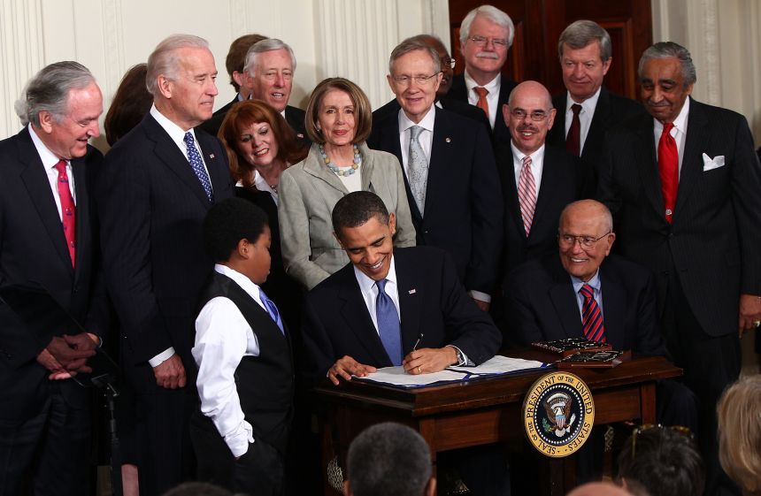 President Barack Obama signs the Affordable Health Care for America Act during a ceremony with fellow Democrats in the East Room of the White House on March 23, 2010 in Washington, DC.