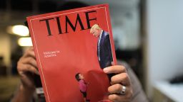 An AFP journalists reads a copy of Time Magazine with a front cover using a combination of pictures showing a crying child taken at the US Border Mexico and a picture of US President Donald Trump looking down, on June 22, 2018 in Washington DC.