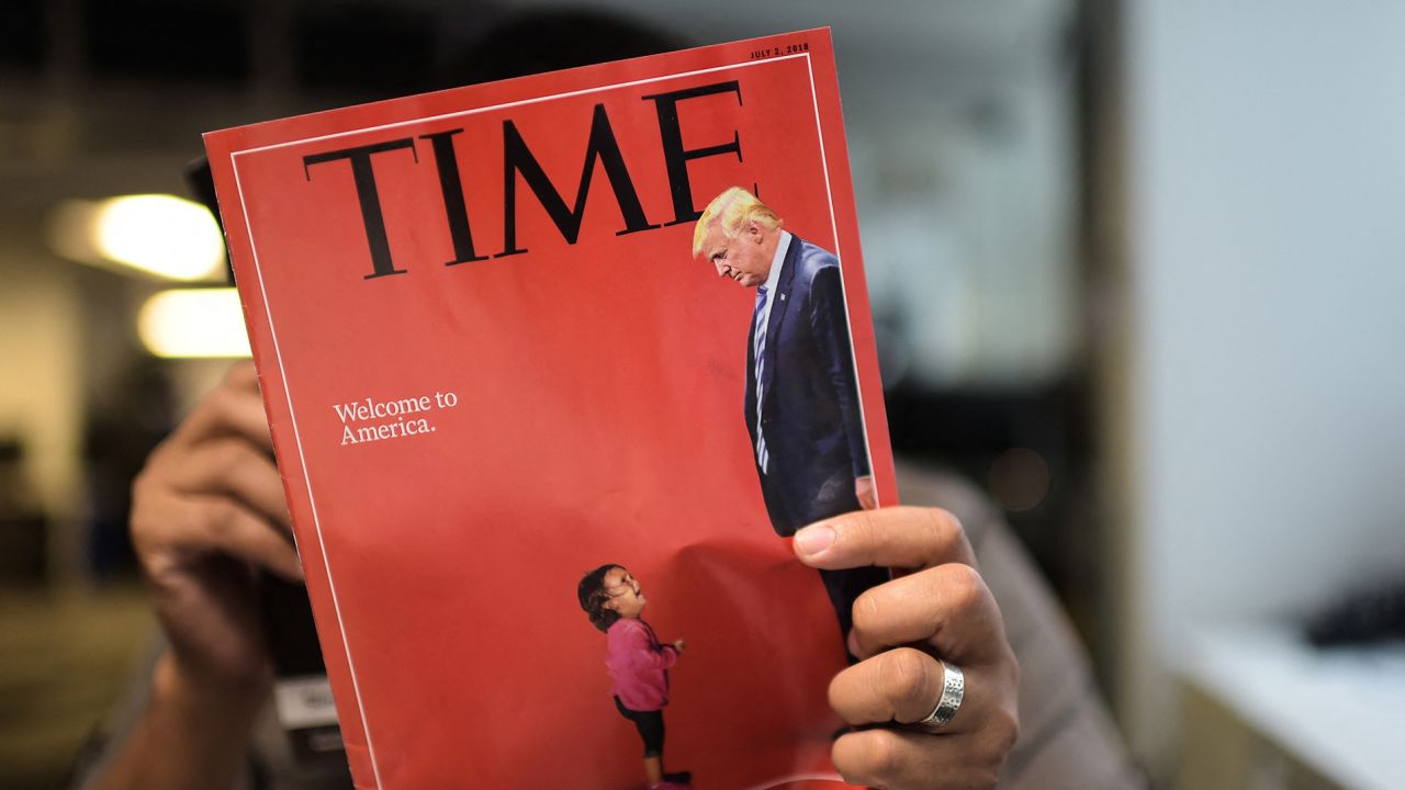 An AFP journalists reads a copy of Time Magazine with a front cover using a combination of pictures showing a crying child taken at the US Border Mexico and a picture of US President Donald Trump looking down, on June 22, 2018 in Washington DC.