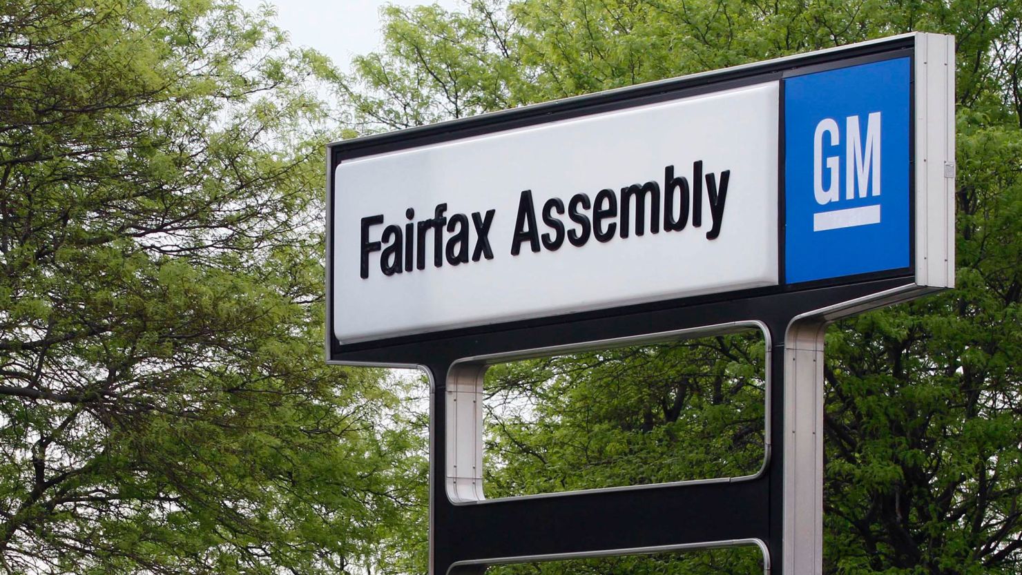 A sign stands outside the GM Fairfax Assembly Plant in Kansas City, Kansas, U.S., on Wednesday, April 21, 2010.  Ed Whitacre, chairman and chief executive officer of General Motors Co., said during an event at the plant that the early repayment of $5.8 billion in government loans and his investment in U.S. car plants show "our plan is working." Photographer: Ed Zurga/Bloomberg via Getty Images