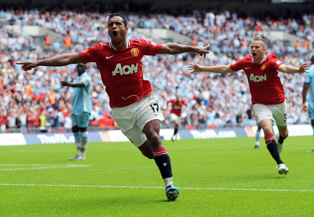 Nani celebrates with teammate Tom Cleverley after scoring United's second goal against Manchester City on August 7, 2011.
