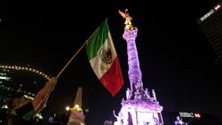 Supporters of the presidential candidate for the "Juntos haremos historia" coalition, Andres Manuel Lopez Obrador, celebrate at the Angel of Independence square in Mexico City, after getting the preliminary results of the general elections on July 2, 2018. Anti-establishment leftist Andres Manuel Lopez Obrador won Mexico's presidential election Sunday by a large margin, according to exit polls, in a landmark break with the parties that have governed for nearly a century. (Photo by Julio Cesar AGUILAR / AFP) (Photo by JULIO CESAR AGUILAR/AFP via Getty Images)