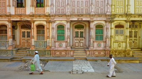 Sidhpur, Gujarat, India - September 16, 2015: Details of the 19th and early 20th century Dawoodi Bohra buildings or Bohrawads, as known locally in Sidhpur, Gujarat. Built by the Dawoodi Bohras, a Shia Muslim trading community from Gujarat. Today more than 100 such buildings exist. All differently colored but in depleted condition. As hardly anybody lives there. Most of the building lie locked. The buildings are laid in rows of narrow, deep structures, about three to four floors high. They have a strong European character with gabled roofs, ornate balconies, pilasters, columns and decorated doors and windows.