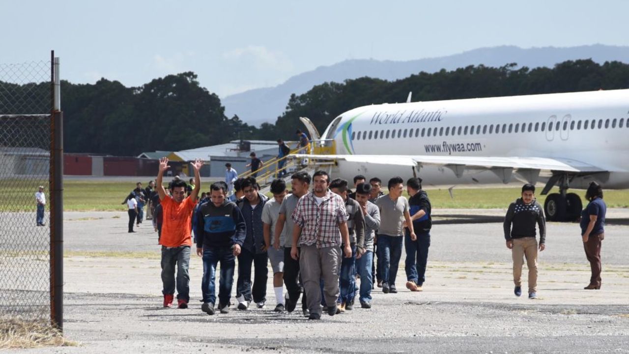 Members of Guatemalan immigrant families who tried to illegally cross to the United States, arrive at the Air Force base in Guatemala City after being deported on July 10, 2018. - Members of 11 Guatemalan families, totalling 106 immigrants, were deported from the United States as US Homeland Security Secretary Kirstjen Nielsen is visiting Guatemala to hold talks with authorities of Mexico and countries of the North Triangle of Central America on the migration crisis unleashed by Washington's "zero tolerance" policy. (Photo by Orlando  ESTRADA / AFP)        (Photo credit should read ORLANDO  ESTRADA/AFP via Getty Images)