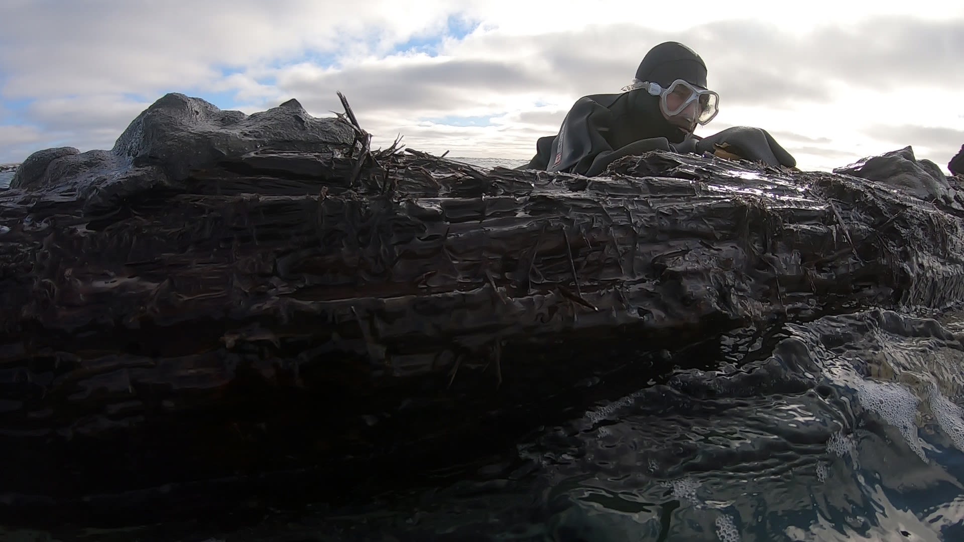 Trevor Croft, also from the Clean Harbours Initiative, attempts to secure parts of the shipwreck to keep it from breaking up in the rough waters off the coast of Cape Ray, Newfoundland, Canada.