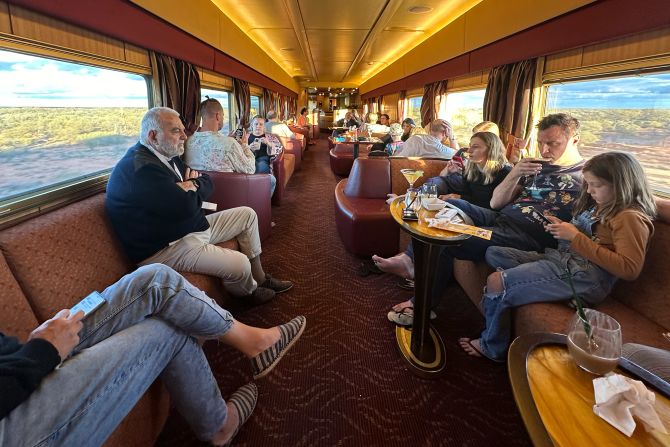 <strong>Explorer's Lounge</strong>: The bar car on the Ghan is always full. Most passengers begin and end their days there, relaxing on long, rounded sofas while playing board games, reading a book or just staring out the large windows that run the length of the car.