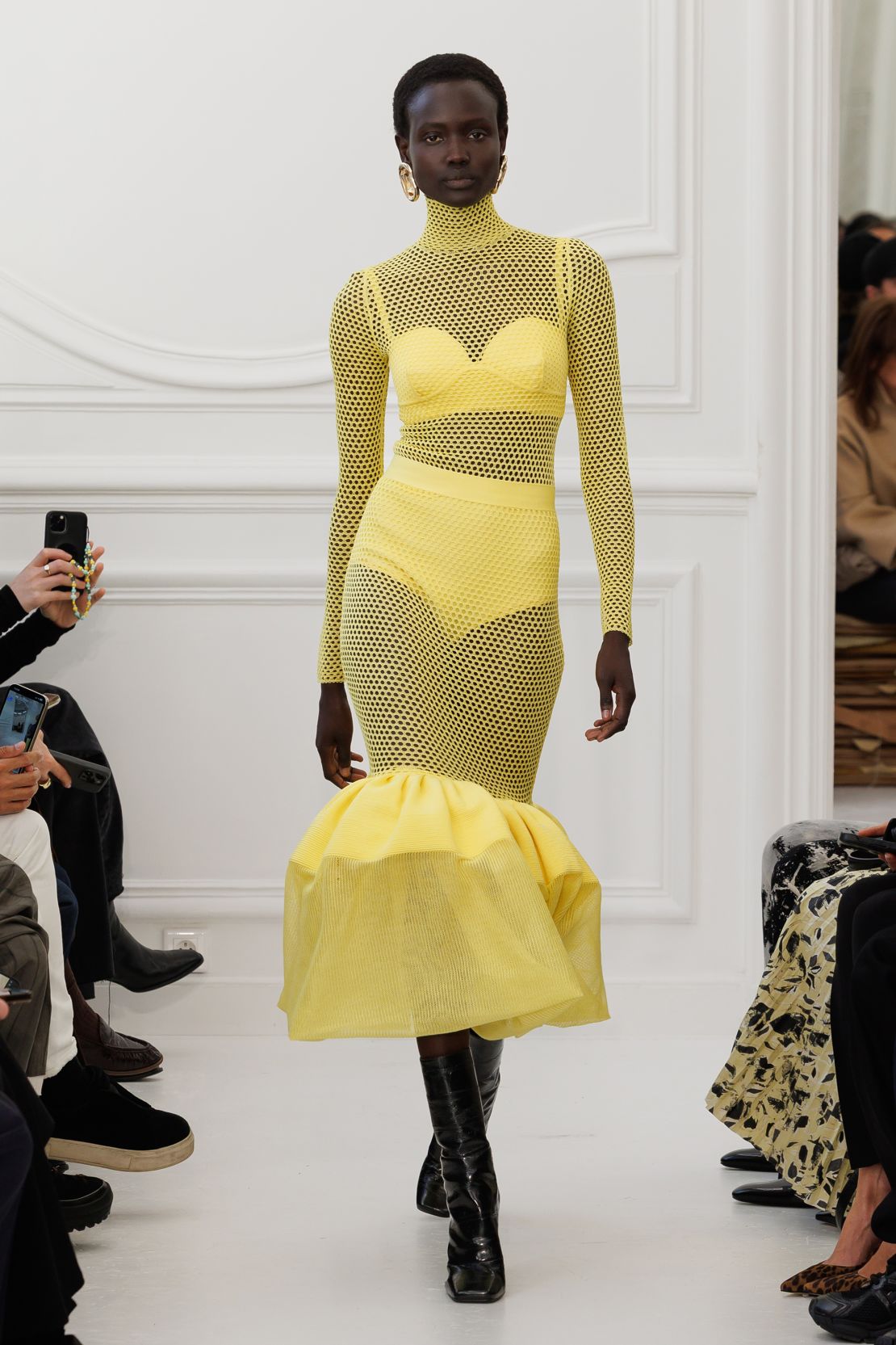 At Givenchy, feminine silhouettes were given a punchy update, with colors such as bright yellow.