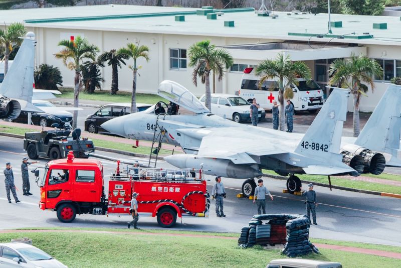 Aircraft tugs pulled the fighter jets on to a road at Naha Air Base on Okinawa to be sure they were not damaged in a possible tsunami.