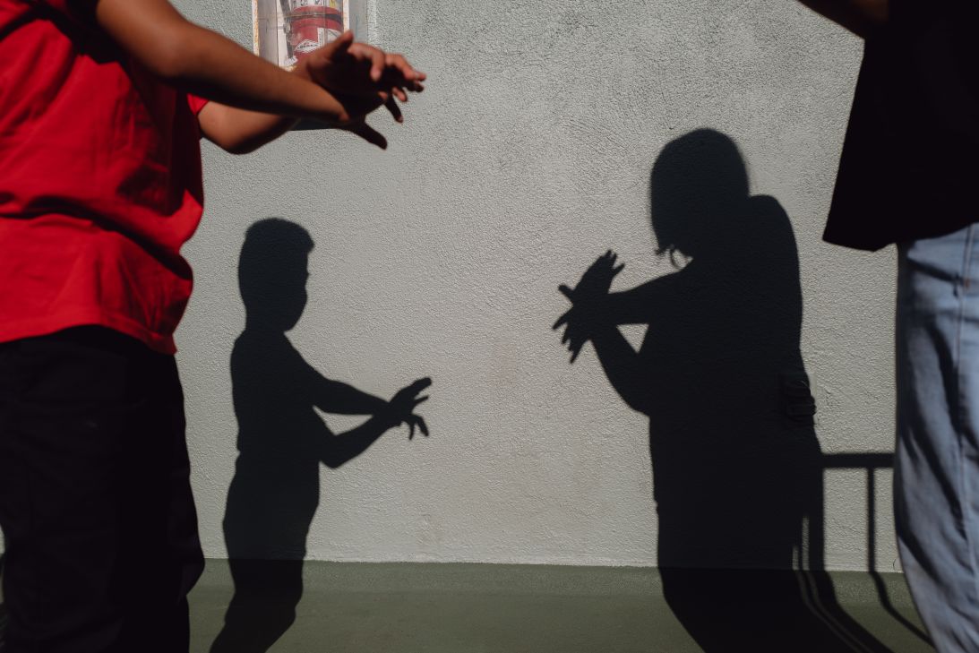 A sister and brother play outside a family member’s apartment complex. Their parents have been deported, leaving them in uncertainty.