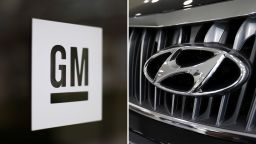 The logos for car manufacturers General Motors, left, and Hyundai.