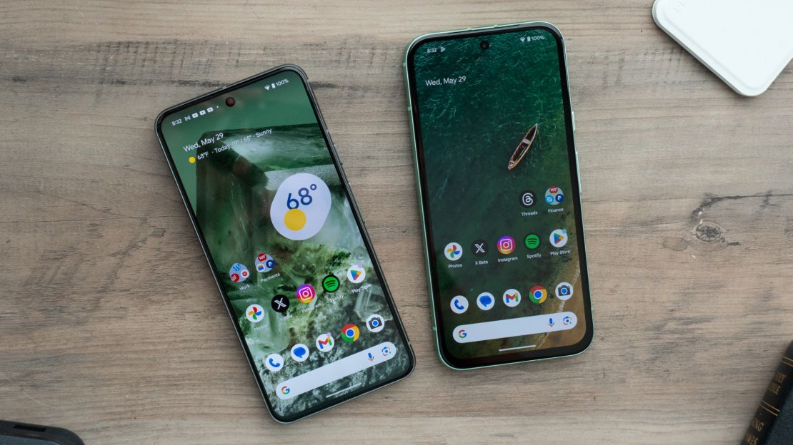 The Google Pixel 8 and Google Pixel 8a are on a table, each displaying their home screen.