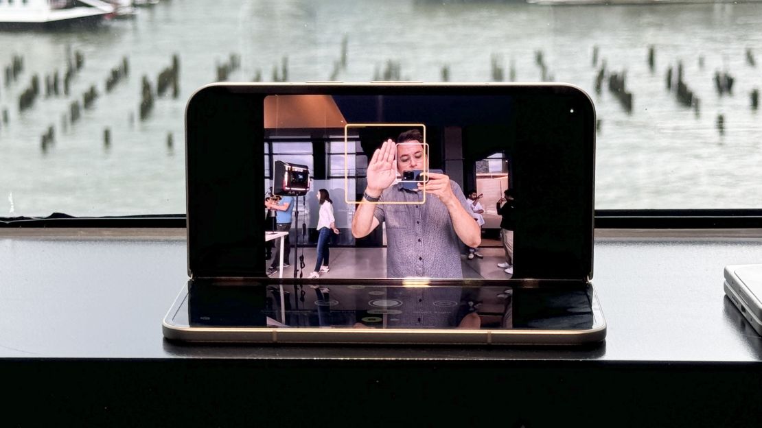 The Pixel 9 Pro Fold is open at a 90 degree angle, and we can see Henry holding a hand up on its screen, and a yellow box outlines that hand.