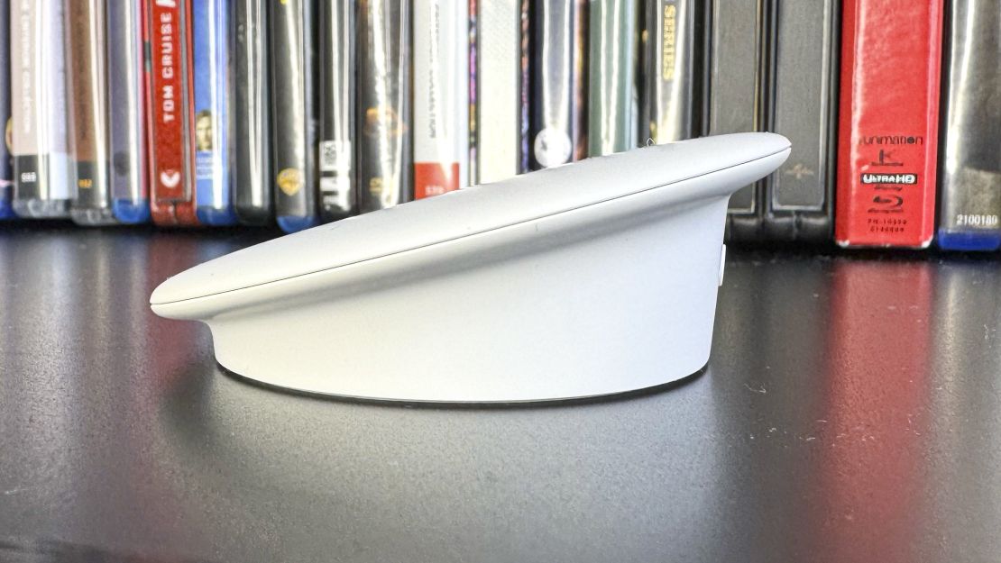 The Google TV Streamer is a wedge-shaped box that is seen here from the side