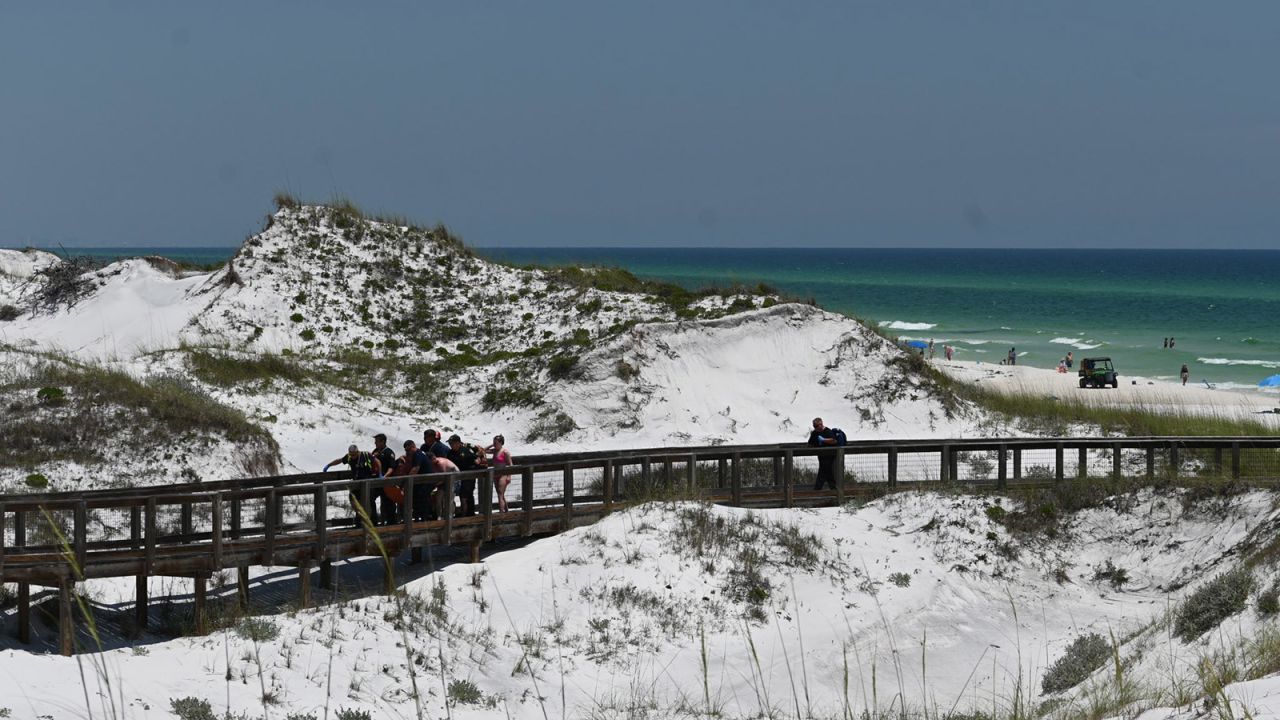 First responders remove an injured woman from the beach after she was bitten by a shark in Walton County, Florida, on June 7, 2024.