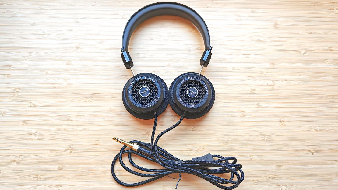 A pair of Grado SR60x headphones on a wooden desk.