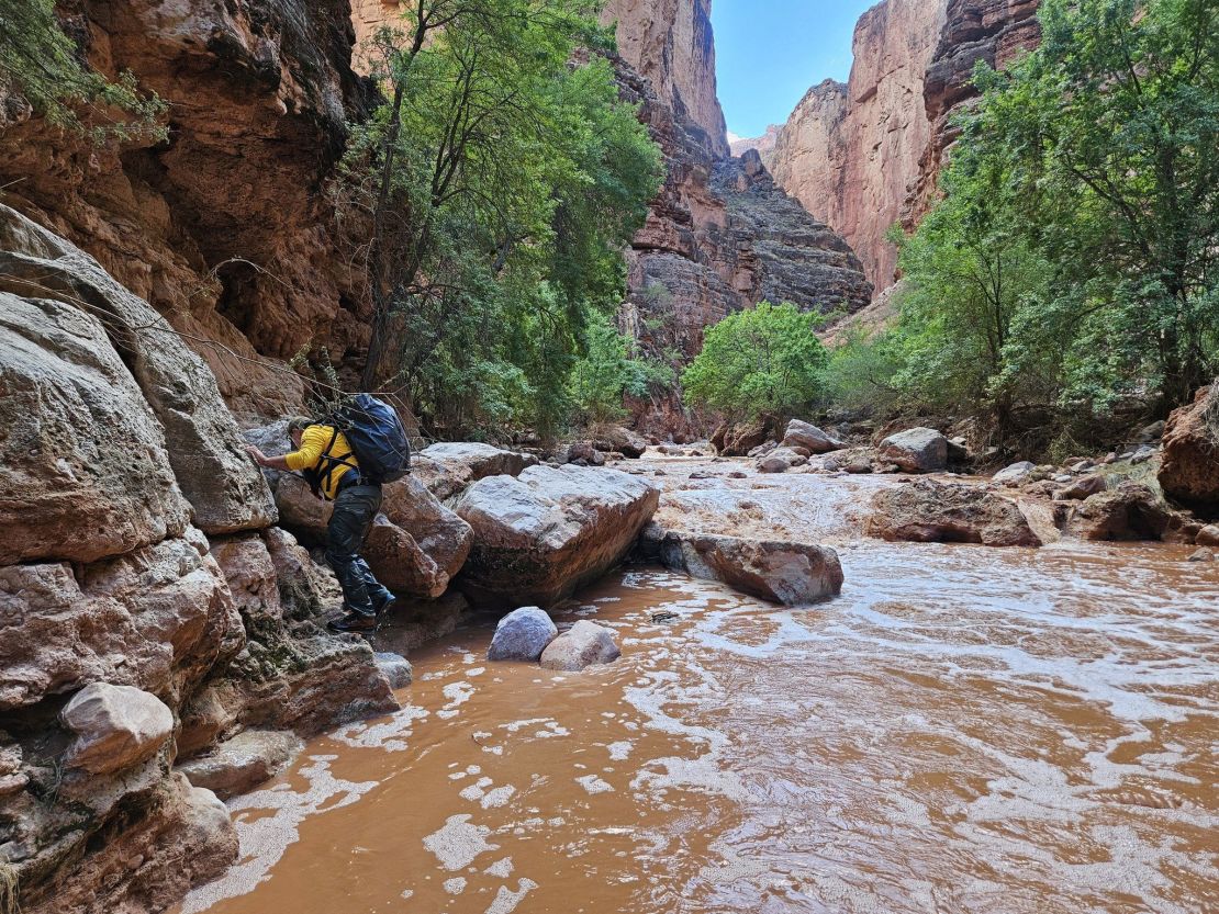 Ground searchers navigate through Havasu Creek after flash floods in Grand Canyon National Park.