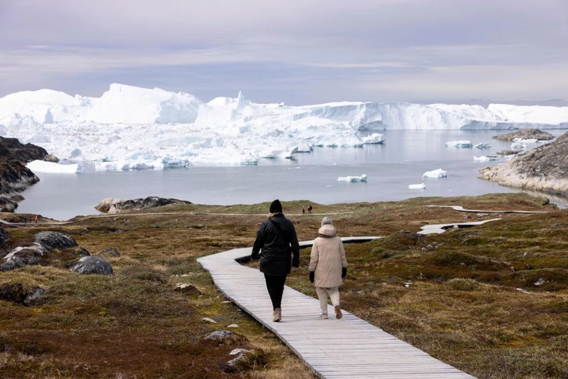 Visitantes pasean por el malecón del Centro de los Fiordos de Hielo (Kangiata Illorsua) en Ilulissat el 29 de junio de 2022.