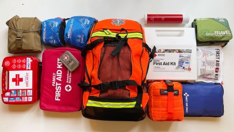 Group of bagged first aid kits laid out on a white tabletop