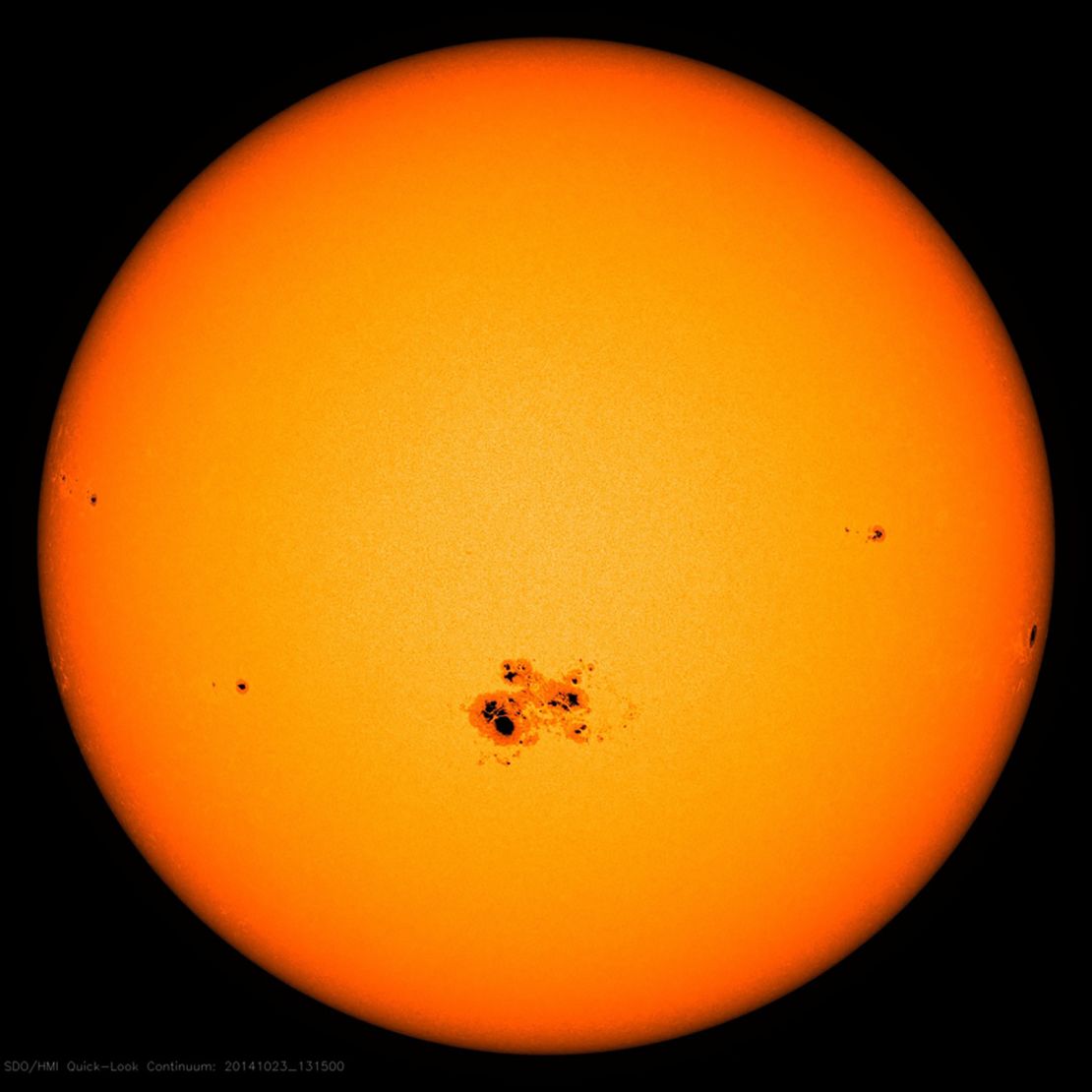 A cluster of sunspots appears on the surface of the sun on October 18, 2014.