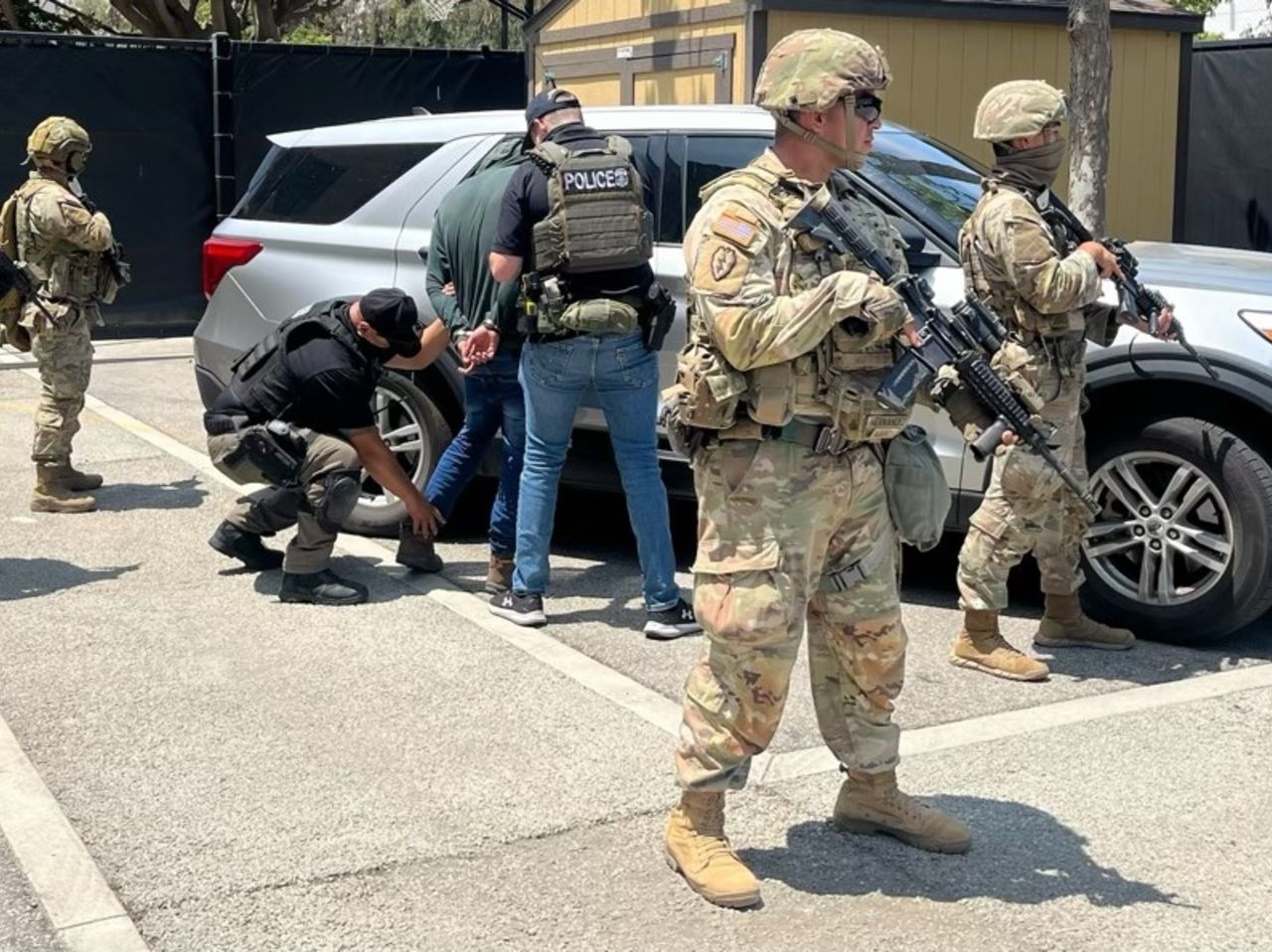 Members of the National Guard guard Immigration and Customs Enforcement officers during an operation in Los Angeles, in this image shared by ICE on Tuesday.